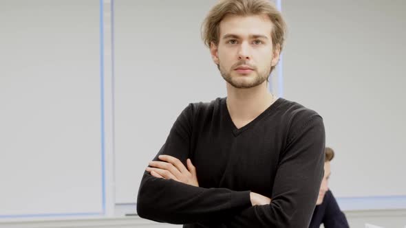 Middle Shot of Confident Handsome Successful Businessman Looking at Camera with Crossed Hands