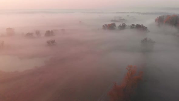 Aerial Drone View of Sunrise Over Misty River