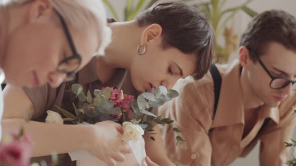 Mixed Aged Florists Decorating Flower Compositions on Masterclass