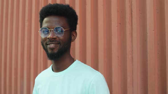 Portrait of Young Cheerful Afro-American Man Outdoors