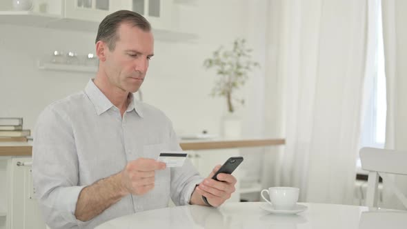 Middle Aged Man Making Successful Payment on Smartphone 