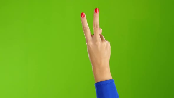 Closeup. Gesture of Peace Shows Hand Woman Twice Per Frame