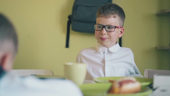 Boy in Shirt Rests with Schoolmate Having Lunch in Canteen