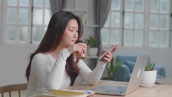 Asian Girl Drinking Coffee While Use Phone