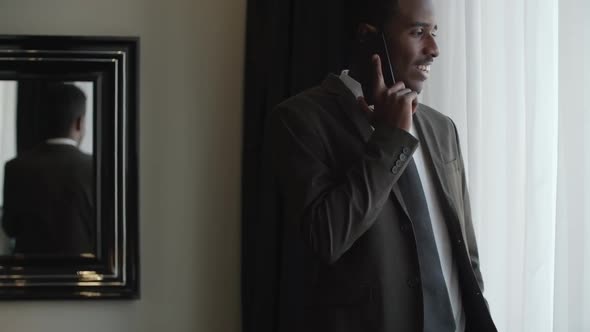 Entrepreneur Speaking on Phone in Hotel Room