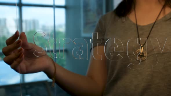 Woman Holding Glass Strategy Sign alt