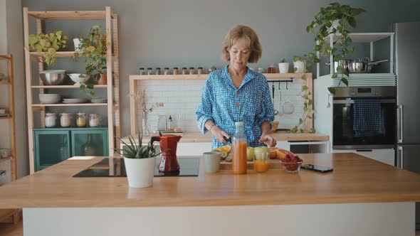 beautiful senior woman spending time in her cozy apartment