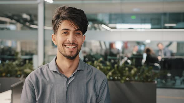 Smiling Happy Millennial Man Arabian Businessman Executive Entrepreneur Looking at Camera Confident