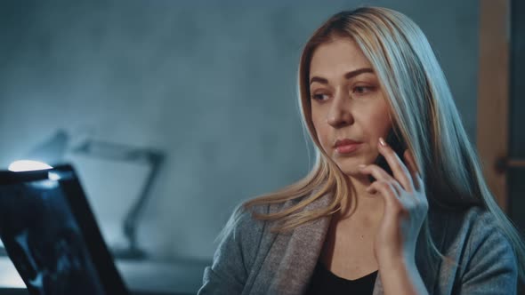 Woman Consults with Therapist Holding Xray Photo in Room