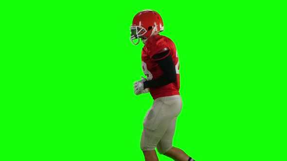 Athlete Runs in Protective Gear with Helmet and Gloves. Green Screen