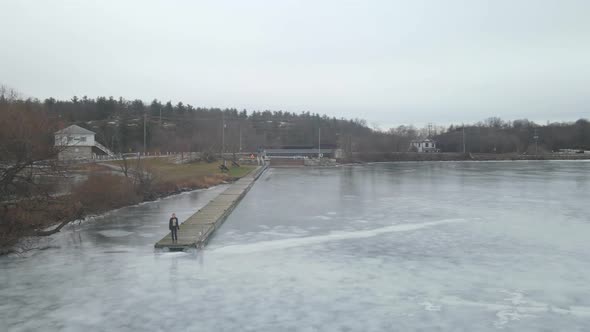 aerial drone following a young woman on a winter day