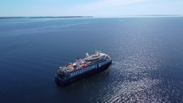 aerial view of cruise ship in open water on a blue sky day