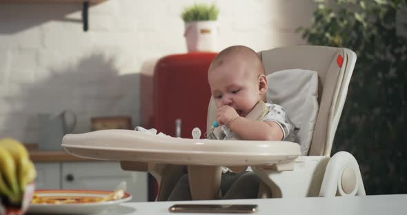 Baby Playing in a High Chair