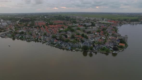 Flying over riverside township in Netherlands