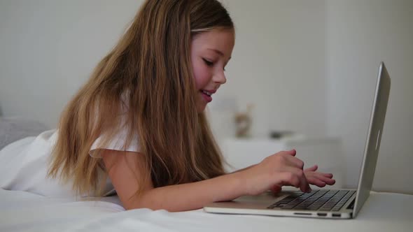 Close Up of Long Haired Beautiful European Girl Typing on Laptop