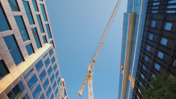 Large Construction Crane in the City Center Near Glass Office Buildings