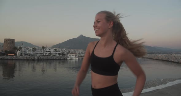 Beautiful Athlete Jogging Along Promenade At Sunset