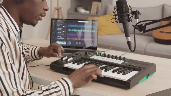 African-American Man Creating Music at Home
