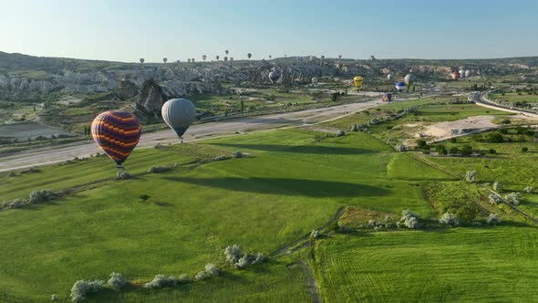 4K Aerial view of Goreme. Colorful hot air balloons fly over the valleys.