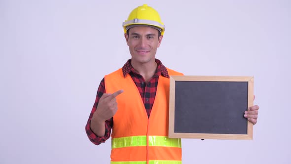 Young Happy Hispanic Man Construction Worker Holding Blackboard and Giving Thumbs Up