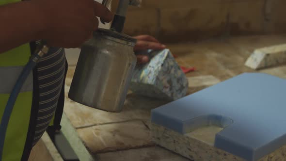 Worker washing a piece of concrete block