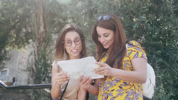 Female tourists with map at Sagrada Familia, Barcelona, Spain