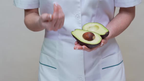 Nutritionist Doctor Healthy Lifestyle Concept - Holding Organic Avocado