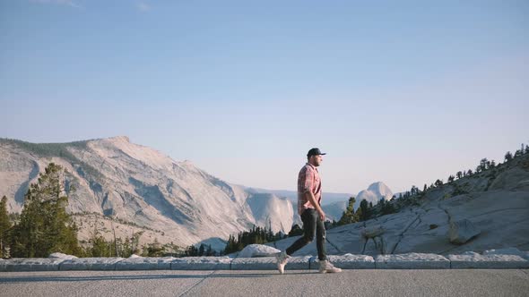 Successful Man Walking Along Epic Mountain Scenery View at Sunny