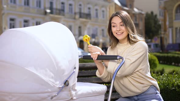 Young Mother Rattle Toy Feeling Tired of Playing With Baby, Parenting Exhaustion