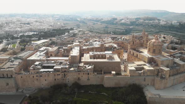 Mdina, view outside city walls overlooking the cityscape limestone buildings in Malta