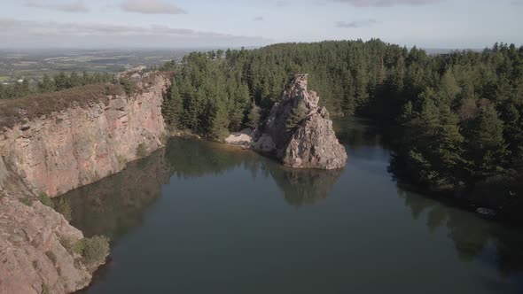 Picturesque View Of Carrigfoyle Quarry Lake With Crag And Coniferous Forest In Barntown, County Wexf