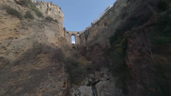 FPV drone flight up Guadalevin River gorge toward Ronda new bridge