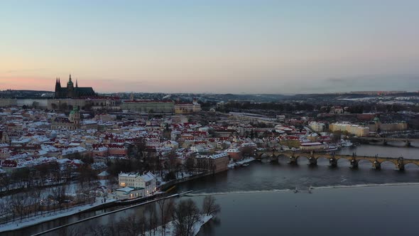 Snow capped Prague, Czech Republic. Aerial view, Charles bridge, castle, Vltava river, St. Virus cat