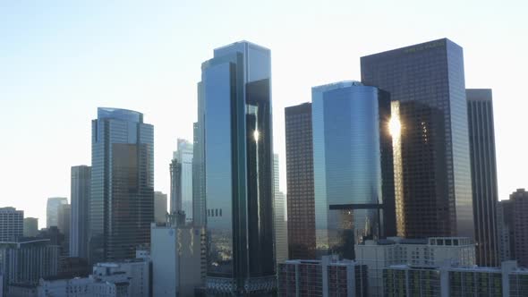 AERIAL: Flying Towards Downtown Los Angeles, California Skyline with Look at Houses and Street