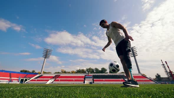 Disabled Footballer Is Playing with a Ball