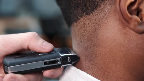 Young Africanamerican Man Visiting Barbershop for Haircut