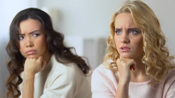 Two Offended Female Friends Sitting Separately, Upset About Quarrel, Friendship