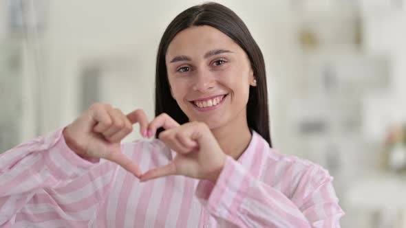 Young Latin Woman Showing Heart Sign with Hand