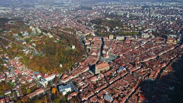 Aerial drone view of Brasov, Romania. Old city centre, residential buildings, yellowed trees