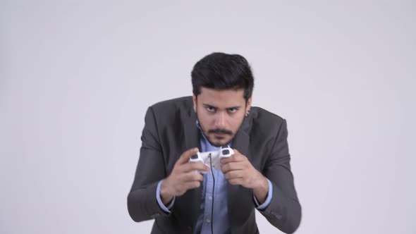 Young Stressed Bearded Indian Businessman Playing Games and Losing