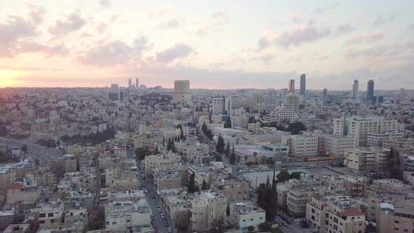 Peaceful and quiet early morning aerial clip of Amman Jordan taken by a drone which slowly pans to t