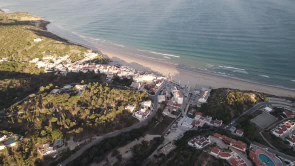 Picturesque seaside Salema village, Algarve. Paradisiac sand beach and emerald sea.