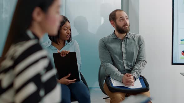 Man and Woman Discussing Hiring Application in Queue