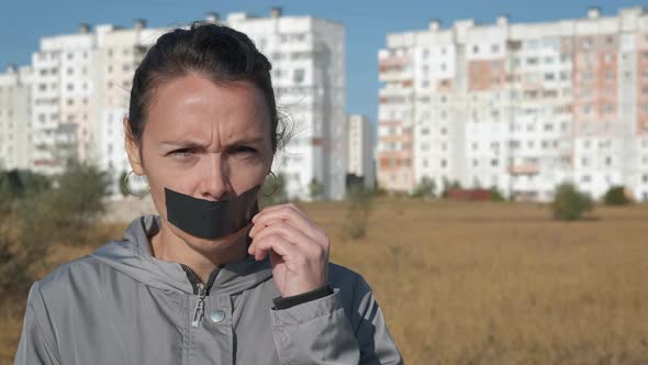 A Woman with Mouth Taped Shut.