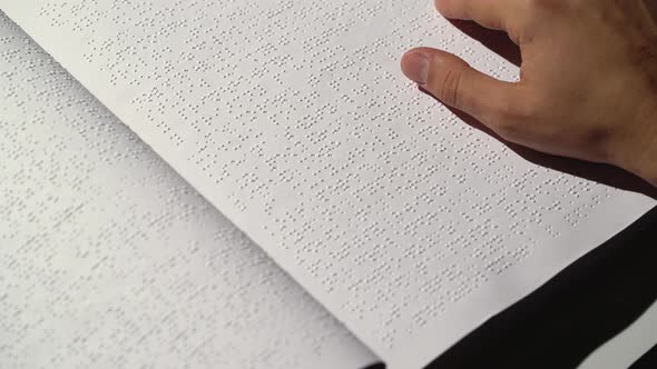 Man Fingers Read Braille Writing. Close Up
