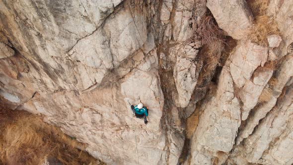 Man Athlette Climbing on the High Rock