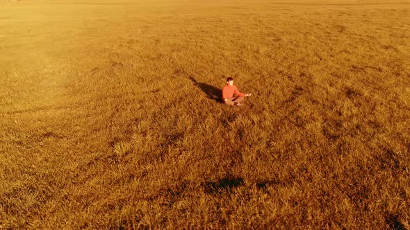 Low Altitude Radial Flight Over Sport Yoga Man at Perfect Green Grass