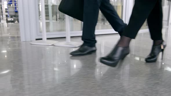 Three clerks going through the hall in office center