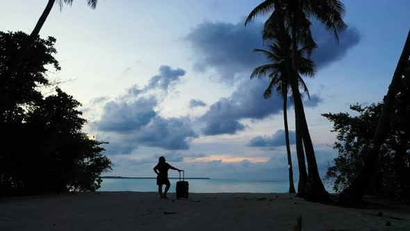 Single female posing on idyllic coast beach lifestyle by blue green ocean with white sand background