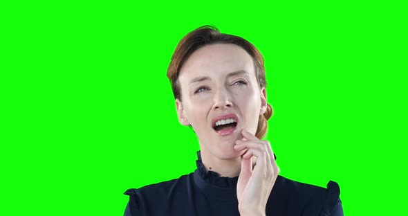 Worried Caucasian woman on green background